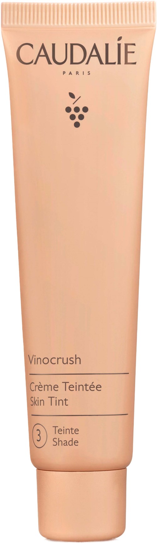 Persikanvärinen Caudalie Vinocrush Skin Tint -putki, sävy 3, tarkoituksena antaa keholle kevyttä sävyä.