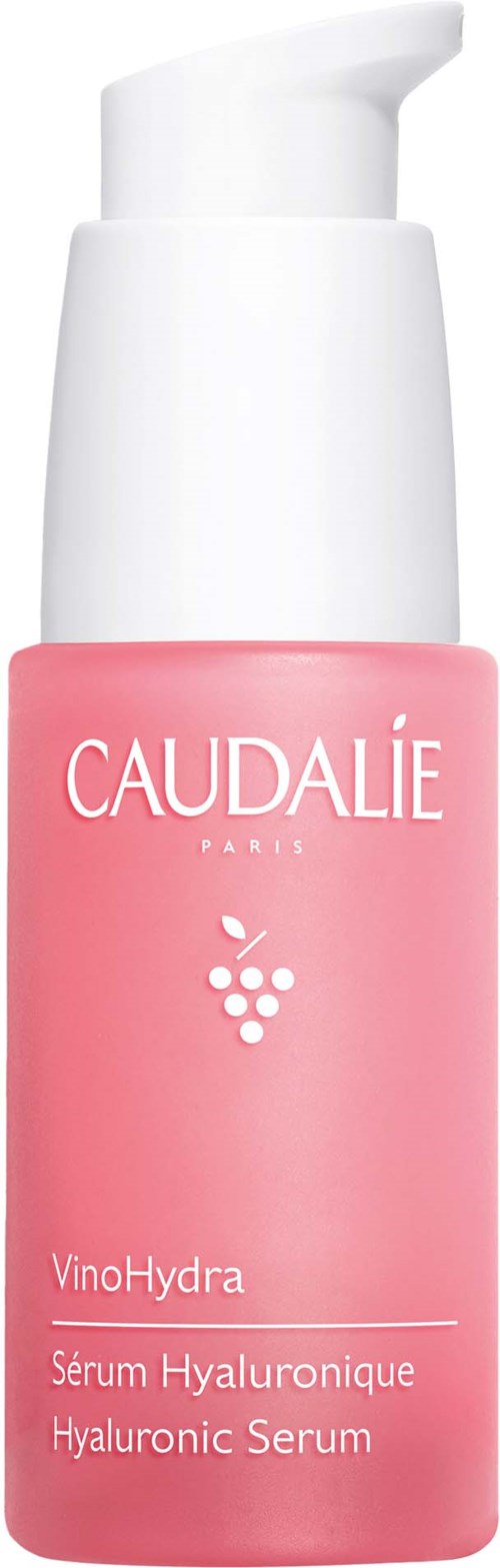 Pink bottle with white pump and text, contains hyaluronic serum for skincare.