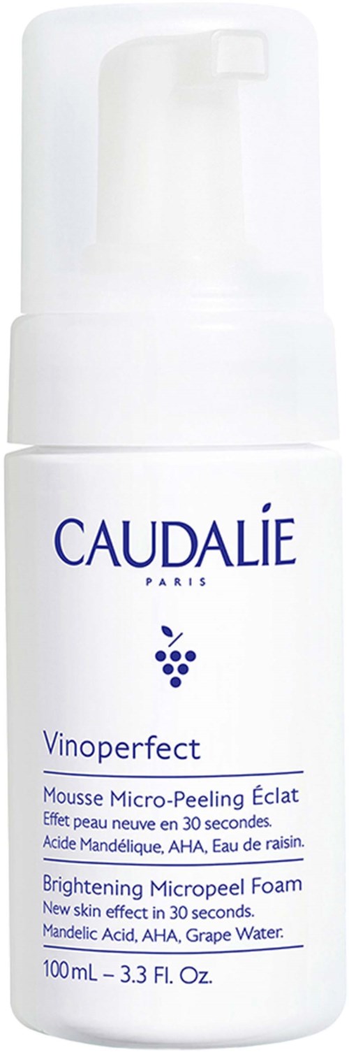 A white bottle of Caudalie Vinoperfect Brightening Micropeel Foam with a pump. It is for skin care and has grape water.