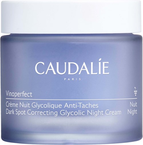 A jar of dark purple night cream labeled 'Caudalie Paris', for dark spot correction and glygolic night treatment.