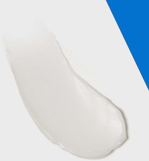A spoon of white cream or yogurt on a plain surface with blue and black accents.