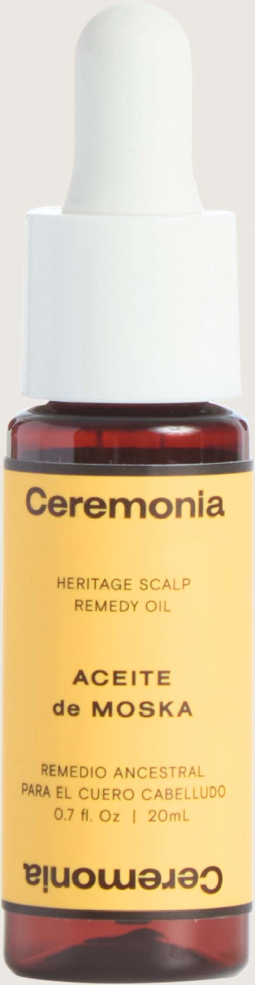 A small bottle with a dropper, labeled Ceremonia Heritage Scalp Remedy Oil, for hair and scalp care.