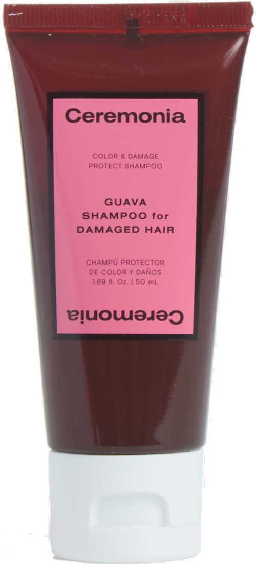 Punainen CeremoniA Guava -shampoopullo vaurioituneelle hiukselle, pinkki tarra ja valkoinen korkki.