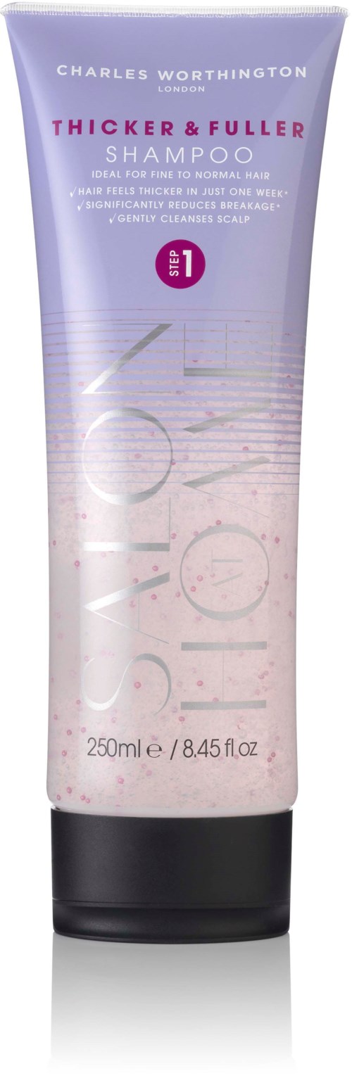Een paarse en witte shampoo tube met zwarte dop, gelabeld Charles Worthington Thicker & Fuller Shampoo, 250ml.