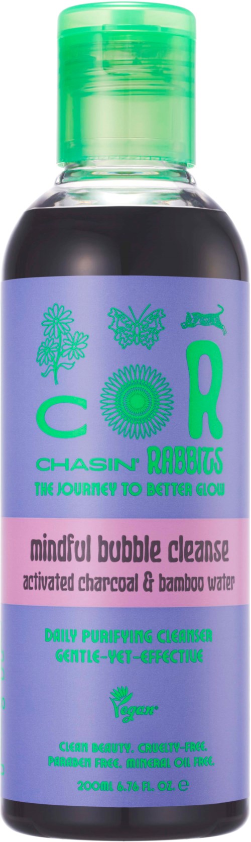A small bottle of facial cleanser with a purple and green label, mentioning bamboo water and activated charcoal.
