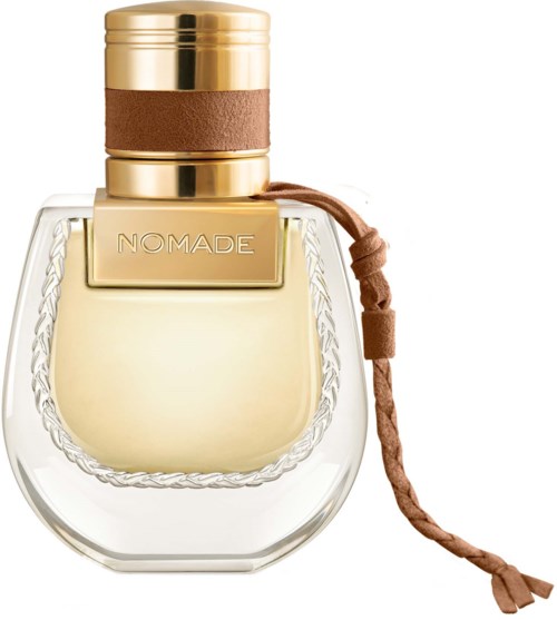 Een parfumflesje met het merk NOMADE, met een gouden en bruine dop en een bruine band aan de zijkant.