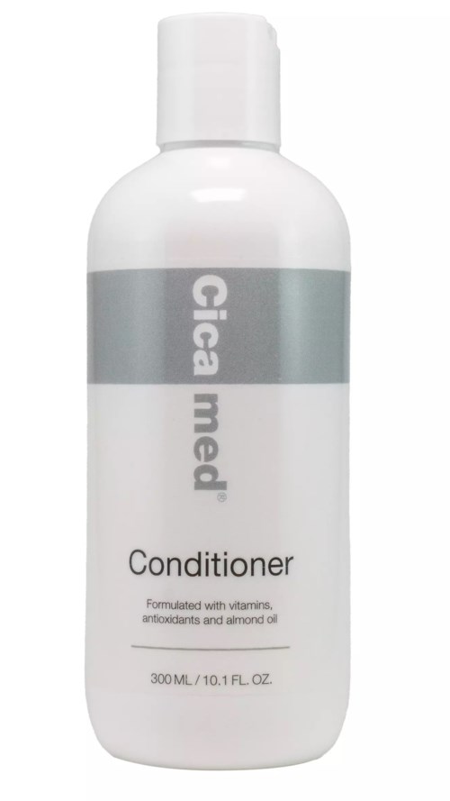 A white bottle of conditioner with gray and black text and cap. Contains vitamins, antioxidants, and almond oil.