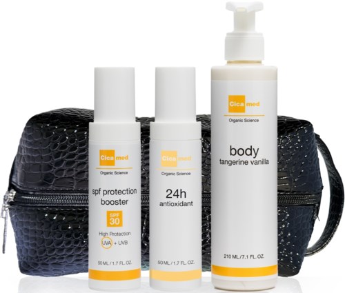 Three Cica med skincare products in front of a black textured bag. They are sunscreen, antioxidant, and body lotion.
