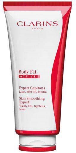 A white and red tube of Clarins Body Fit cream, promoting skin smoothing and toning benefits.