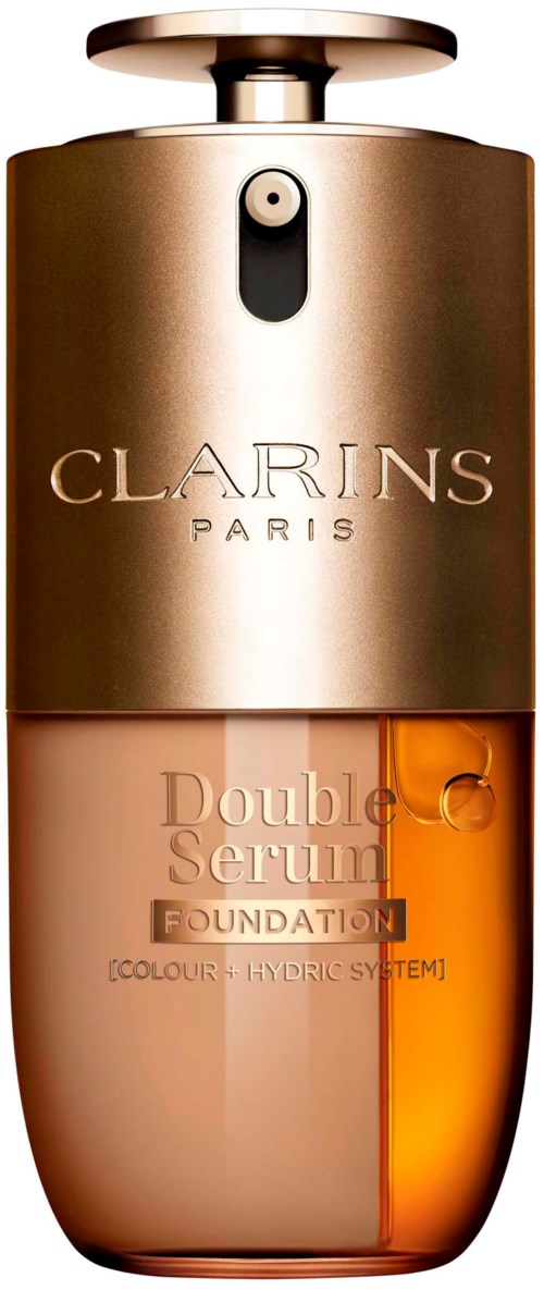 En Clarins-forsyning med gullhode, mørk og lys beige kropp, og oransje serum inni.