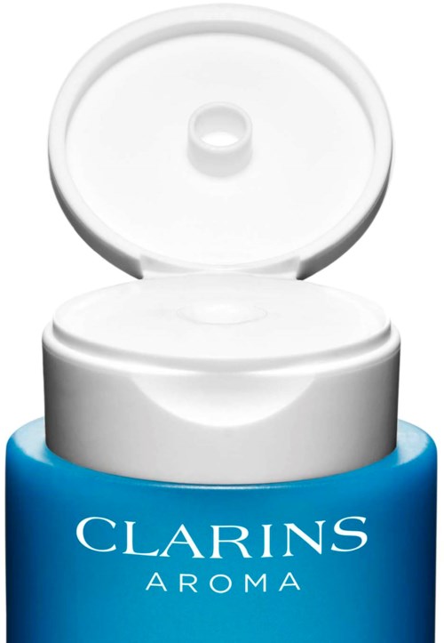Een blauwe fles Clarins Aroma crème met een open wit deksel.