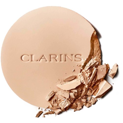A beige pressed powder with crushed pieces on the bottom right and the word 'CLARINS' embossed in the center.