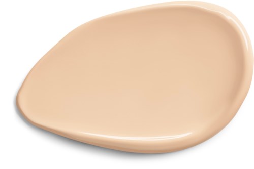 En beige, slät droppformat tallrik med lätt kurviga kanter.