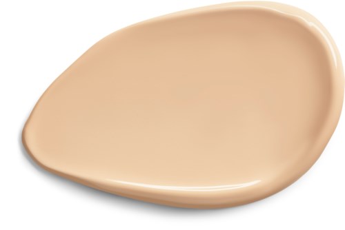 En beige, oregelbundet formad makeupborste applicerar foundation. Slät, glänsande yta med rundade kanter.