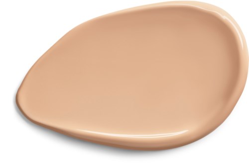 Ett beige, tårformigt prov på makeupgrund eller concealer på vit bakgrund.