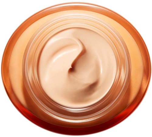 Creamy beige face cream in a round jar, viewed from above with some swirls on the surface.