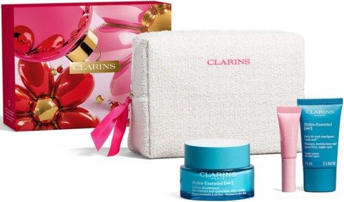 Beauty gift set includes a pink box, white towel bag with pink ribbon, and skincare products in blue and pink containers.