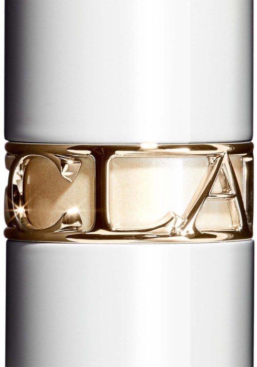 A close-up of a silver and gold ring with engraved letters, possibly initials, on a white background.