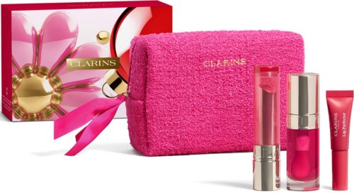 Beauty gift set with pink bag, perfume, lip gloss, and skincare tubes in pink and silver.