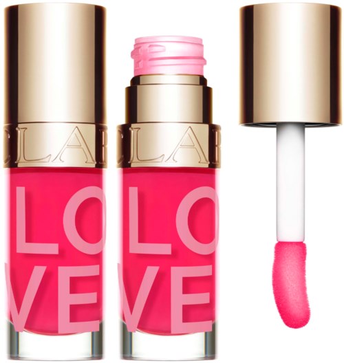 Een roze lipgloss met een gouden dop, toont de applicator en de felle kleur binnen.