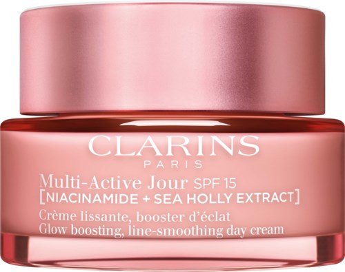 Vaaleanpunainen voidepurkki Clarins, SPF 15, niacinamide ja meriholly-ekstrakti, kirkastukseen ja tasoittamiseen.