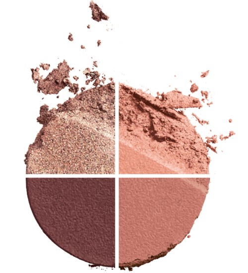 Four shades of pressed powder makeup, some broken with loose particles scattered around.