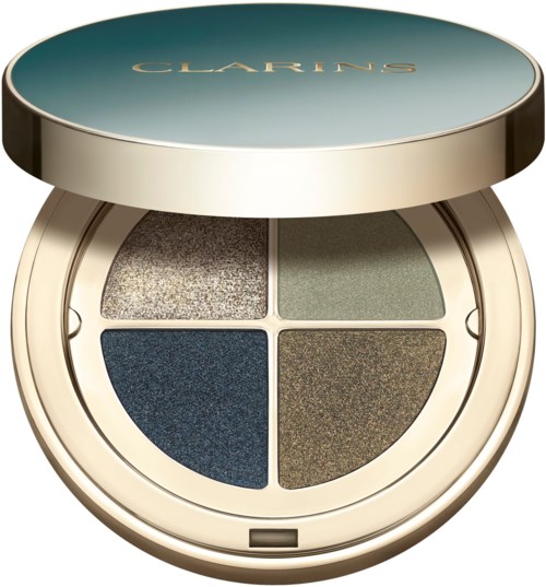Een ronde make-up palette met vier metallic oogschaduwen in een beige case, met een blauwe bovenkant. Negentien woorden.