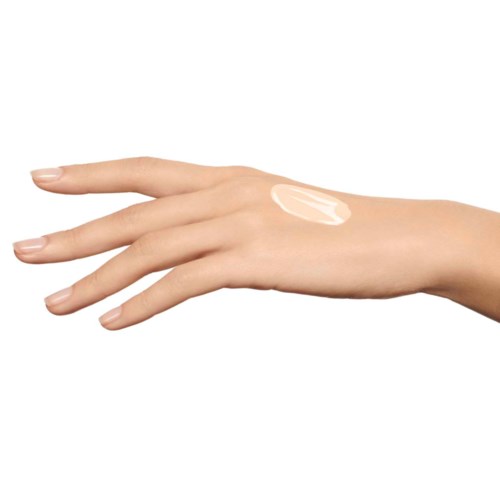Hand with a dollop of cream or lotion on the back. Clear background, focus on skin and product.
