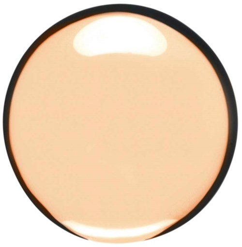 A round, beige-colored makeup compact with a black border and a shiny, reflective surface.
