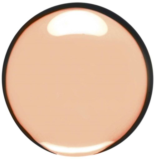 A round, peach-colored makeup product with a black border, possibly a blush or eyeshadow. Reflective light on top.