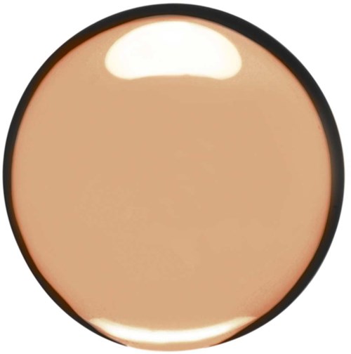 Een ronde beige make-up, met een donkere rand en een glanzend, glad oppervlak.