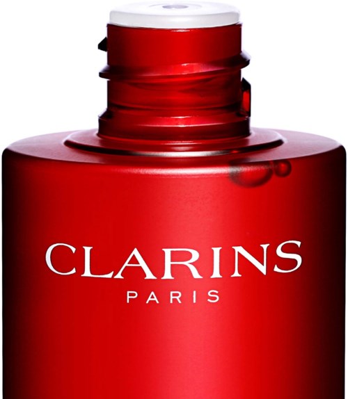 Punainen pullo valkoisella korkilla, jossa lukee 'Clarins Paris'.