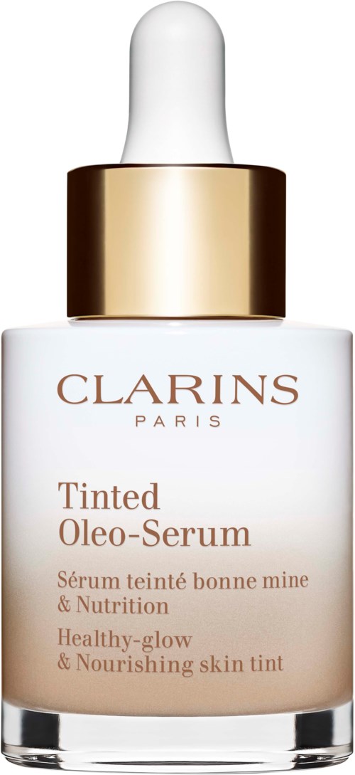 A white bottle with a gold cap containing Clarins Tinted Oleo-Serum, a skincare product for nourishing and glowing skin.