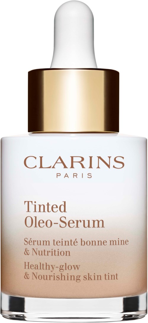 A Clarins Paris skincare bottle with a white dropper, gold band, and text about tinted oil serum for glowing, healthy skin.