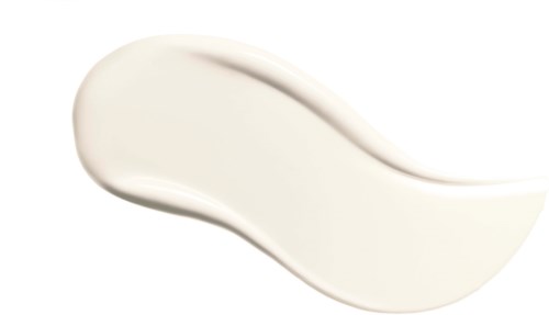 A white cream is spread in a curved shape on a white background.