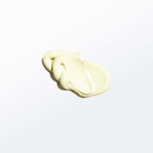 A small dollop of white, creamy substance on a white background.