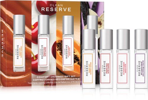 Set of five travel-sized perfume bottles with white labels and silver caps, labeled Clean Reserve and Reserve. Background shows fruit images.