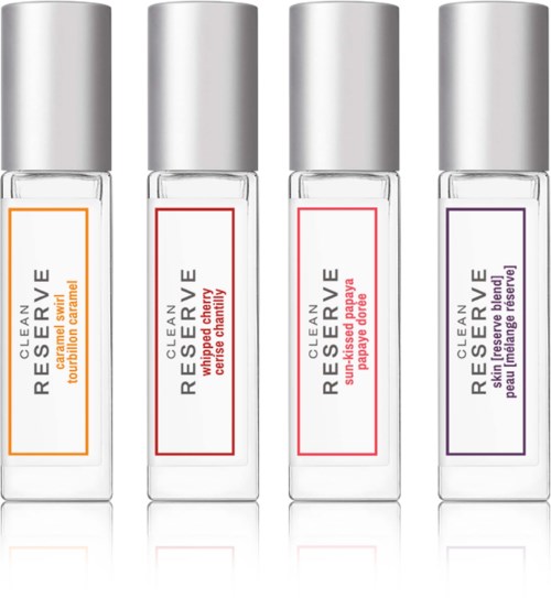 Four small clear bottles of perfume labeled with different scents: caramel, cherry, papaya, and blue peony.