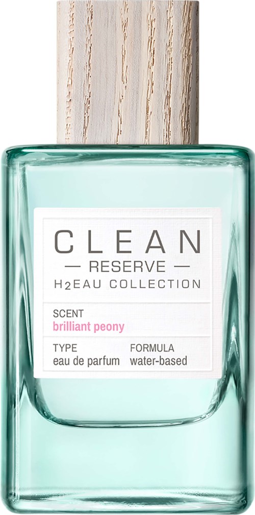 Eine Glas-Parfümflasche mit Holzdeckel, beschriftet 'CLEAN RESERVE' und 'brilliant peony'-Duft.