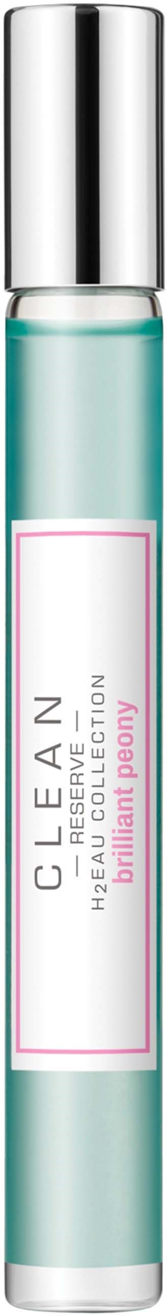 Een kleine heldere fles met een zilveren dop, met label 'CLEAN' en 'luminous peony'.