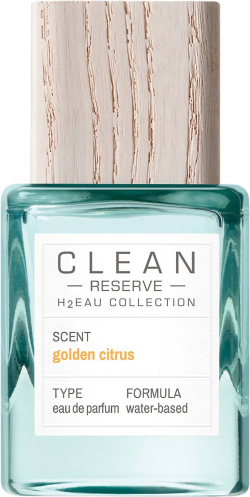 Een parfumfles met turquoise vloeistof, witte etiket, houten dop en tekst over geur en collectie.