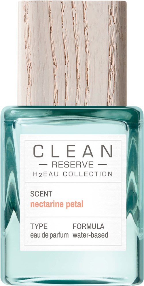 Een parfumpop met een beige dop en een witte label, die aangeeft dat het een watergebaseerde geur met nectarinepetal geur is.