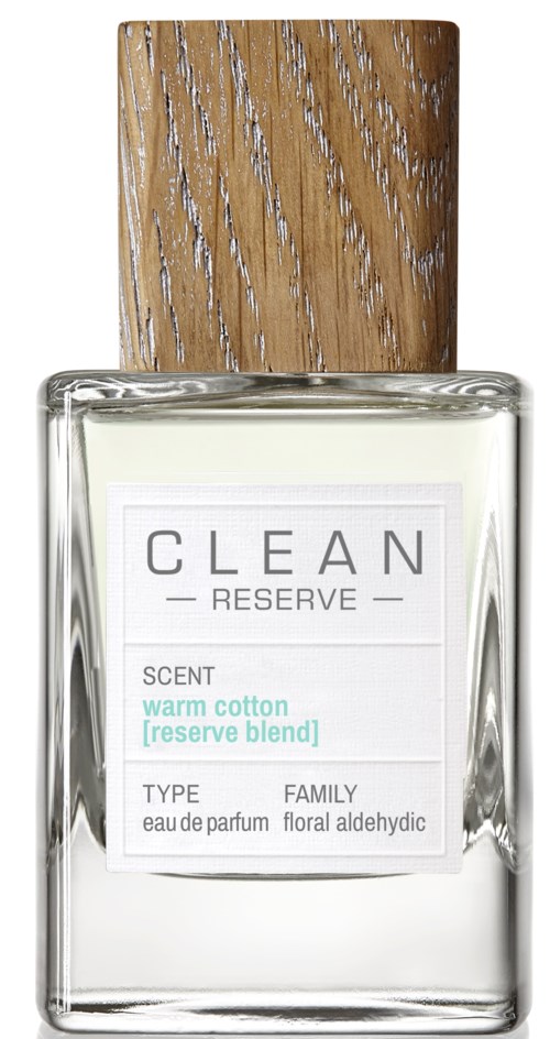 Een parfumfles met een houten deksel, helder glas en een wit label. Het label zegt 'CLEAN RESERVE' en 'warm cotton' geur.