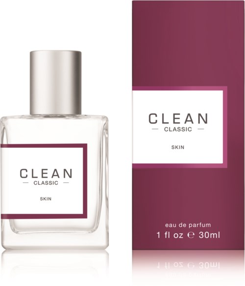 Een heldere glazen parfumfles met een zilveren dop en een paarse en witte dooslabel. Het label leest 'CLEAN CLASSIC SKIN' en 'eau de parfum 30ml'.