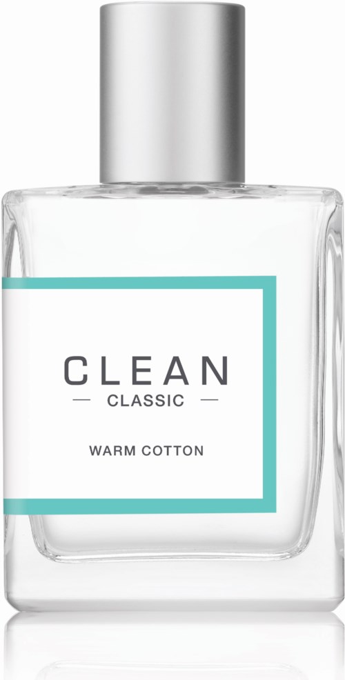 Een heldere glazen fles met een zilveren dop met het label 'CLEAN CLASSIC WARM COTTON'.