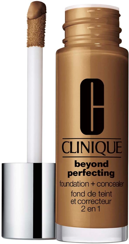Een flesje Clinique 'Beyond Perfecting' foundation en concealer met een applicator. Goudkleurige container.