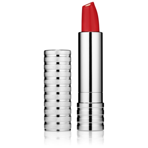 A lipstick with a red color stands next to a stack of silver round containers.