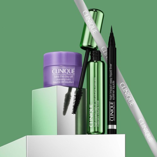 Clinique skincare and makeup products including a cleansing balm, mascara, and eyeliner arranged on a white surface.