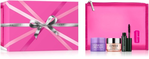 Beauty gift set in a pink box with a silver ribbon, includes skincare and makeup products and a pink bag.