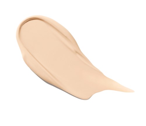 Een beige vloeibare foundation test aangebracht op een witte achtergrond.